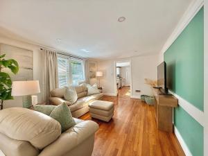a living room with a couch and a tv at North Haven Rooms in North Haven