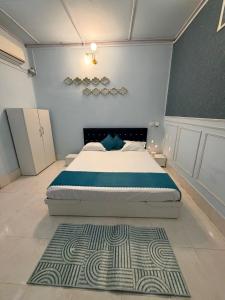 a bedroom with a bed and a rug on the floor at Vina Homestay in Jorhat