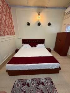 a bedroom with a large bed in a room at Vina Homestay in Jorhat