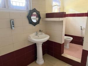 a bathroom with a sink and a toilet at Vina Homestay in Jorhat