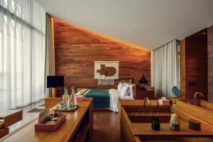 a bedroom with a bed and a sink in a room at Desa Potato Head Bali in Seminyak