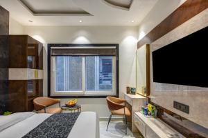 a hotel room with a bed and a flat screen tv at Hotel Byland Inn- Near Connaught Place And 5 Minutes From New Delhi Station in New Delhi