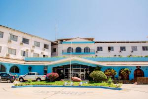 a hotel with a blue and white building at Hotel Pacífico Talara in Talara