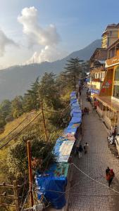 a row of blue tarps lined up on a street at Krishna Holiday Guest House in Dharmsāla