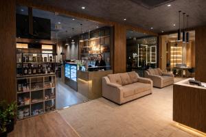 a woman standing at a bar in a hotel lobby at MoonBasa Boutique Hotel and Spa Infopark , Kakkanad in Cochin