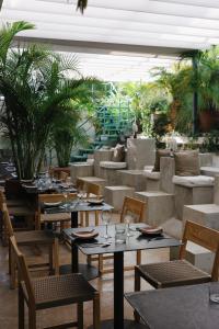 a restaurant with tables and chairs and plants at Casa TO - Adults Only in Puerto Escondido +19 photos