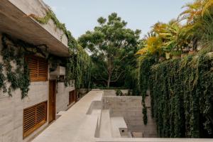 a courtyard with a bench in front of a building at Casa TO - Adults Only in Puerto Escondido