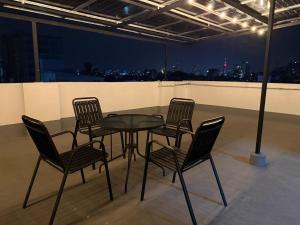 a table and chairs in a room with a view at The Colombo Charm in Colombo