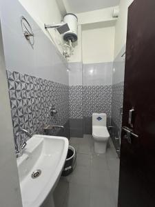 a bathroom with a sink and a toilet at Panwar home stay in Partābnagar