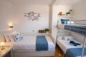 two beds in a small room with two bunk beds at Holibai, Son do mar apto con terraza y vistas a la bahia de Baiona in Baiona +23 photos