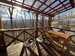 a wooden deck with a bench and a table on it at holidayhouse SERENADE in Nasu