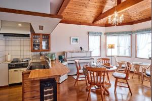 a kitchen and dining room with a table and chairs at holidayhouse SERENADE in Nasu