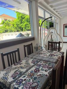 a dining room with a table and chairs and a window at Vientiane Villa Ruby Hotel in Vientiane