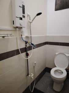 a shower in a bathroom with a toilet at Ayla Hostel at MITC in Ayer Keroh +15 photos