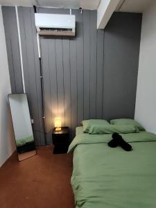 a bedroom with a bed and a mirror next to a mirror at Ayla Hostel at MITC in Ayer Keroh