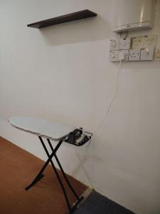 a table in front of a wall with a lightswitch at Ayla Hostel at MITC in Ayer Keroh
