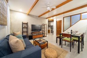 a living room with a blue couch and a table at The Wander Nest Villas in Panglao Island