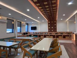 a conference room with tables and chairs and a tv at The Grand Maan Palace and Resort- Near Vaishali Nagar I New Building in Jaipur