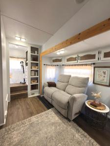 a living room with a couch and a table at The Pendle-Tin in Pendleton