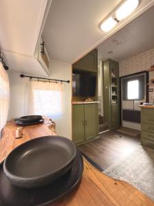 a kitchen with a large black sink on a wooden table at The Pendle-Tin in Pendleton