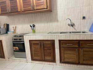 a kitchen with a sink and a stove at MySuiteStays Keyless 3Bed Apt in Sacre Coeur in Dakar +11 photos