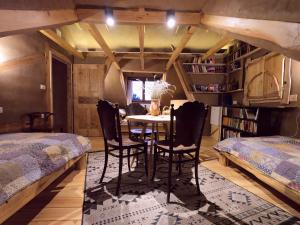 a bedroom with a table and chairs in a room at Šumska 1 - Fruška gora in Sremska Kamenica