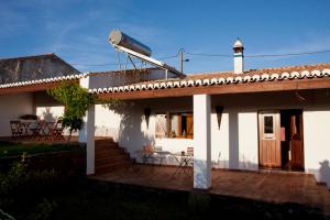 a white house with a satellite dish on the roof at Ecoland Casa de Campo in Mértola