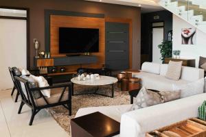 a living room with a couch and a table at Luxe Life House in Sheffield Beach
