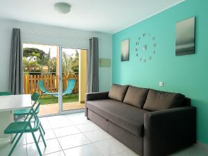 a living room with a couch and a table at Maspalomas Green Oasis 1404 in Maspalomas