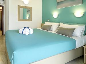 a bedroom with a blue bed with a pillow on it at Maspalomas Green Oasis 1404 in Maspalomas +10 photos
