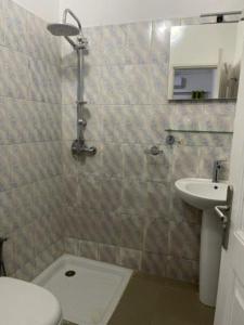 a bathroom with a toilet and a sink at MySuiteStays Keyless 3Bed Apt in Sacre Coeur in Dakar