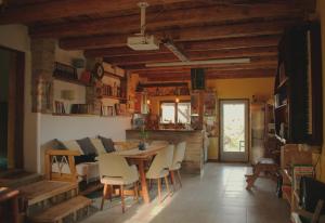 a kitchen and dining room with a table and chairs at Šumska 1 - Fruška gora in Sremska Kamenica