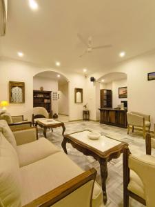 a living room with a couch and a table at Ramat Niwas By Kutani Stays in Jaipur +31 photos