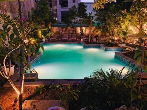 a swimming pool at night with chairs and trees at Ramat Niwas By Kutani Stays in Jaipur