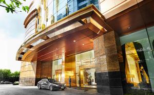 曼谷的住宿－通羅素坤逸中心55超豪華酒店，停在大楼前的汽车