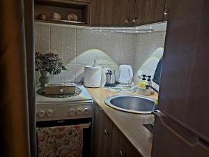 a kitchen with a sink and a counter top at Stan na dan Bijeljina centar in Bijeljina +25 photos
