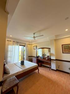 a large room with a bed and a desk at Hotel Grand Luis in Dauis