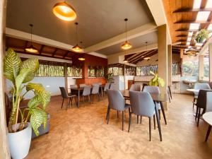 a restaurant with tables and chairs and plants at The Hills By First Team in Kandy
