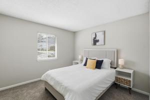 a white bedroom with a bed and a window at Comfort & Convenience in Stone Mountain in Stone Mountain +12 photos
