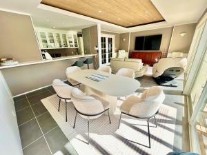 a living room with a white table and chairs at Waterfront Hideaway in Miyazaki