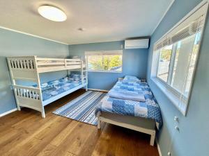 a bedroom with a bed and a bunk bed at Waterfront Hideaway in Miyazaki +24 photos