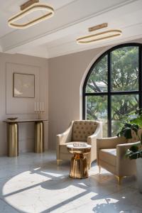 a living room with a chair and a table at Grandala Suites - A Boutique Hotel in Cochin +91 photos