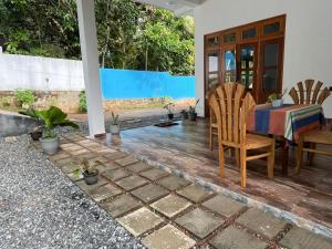 a patio with a table and chairs in a house at Lio Villa in Habaraduwa Central