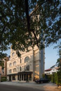 a building with a car parked in front of it at Grandala Suites - A Boutique Hotel in Cochin