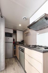 a kitchen with white cabinets and a stove top oven at Chez gaby in Lagorce +5 photos