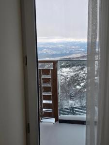 a room with a window with snow on the ground at Sky Nest Kopaonik in Kopaonik +7 photos