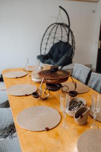 a wooden table with plates and glasses on it at Mini Хаус Ясіня in Yasinya