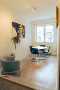 a living room with a table and chairs and a window at Lyves in Liège