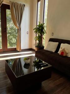 a living room with a couch and a coffee table at Cabaña Sendero De Las Luciernagas in Zacatlán