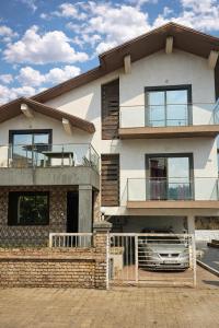 a house with a car parked in front of it at Hangout Villa in Malavli